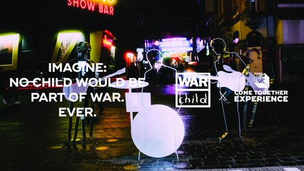 The Logos of War Child Germany and the Come Together Experience Hamburg shown together in front of a picture of nightlife in Hamburg